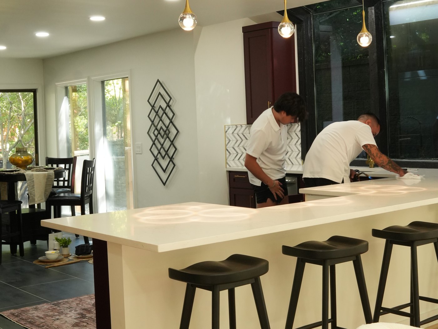 Two Lithos installers finishing a filmed kitchen island